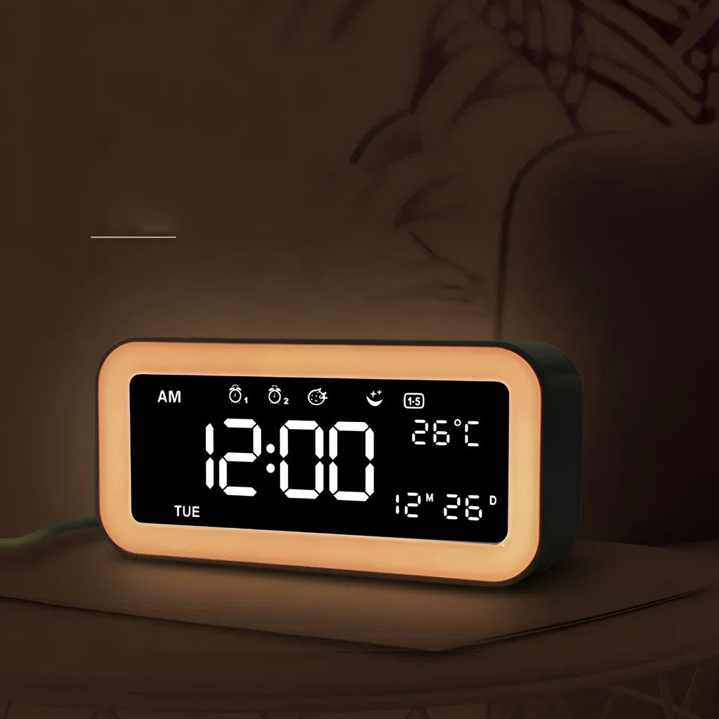 Blue rectangular LED atmosphere light alarm clock with digital display on a table.