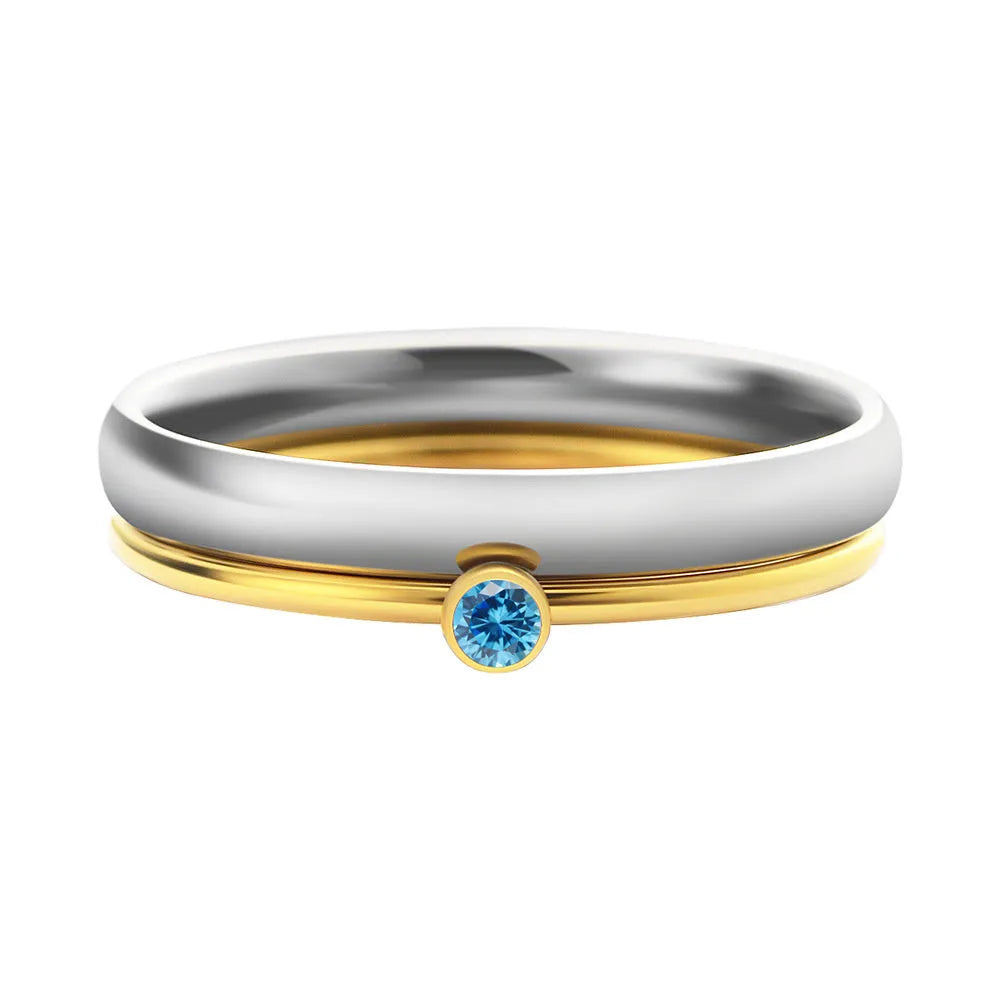 Close-up of a geometric titanium steel ring with an engraved December birthstone colour design on the band.