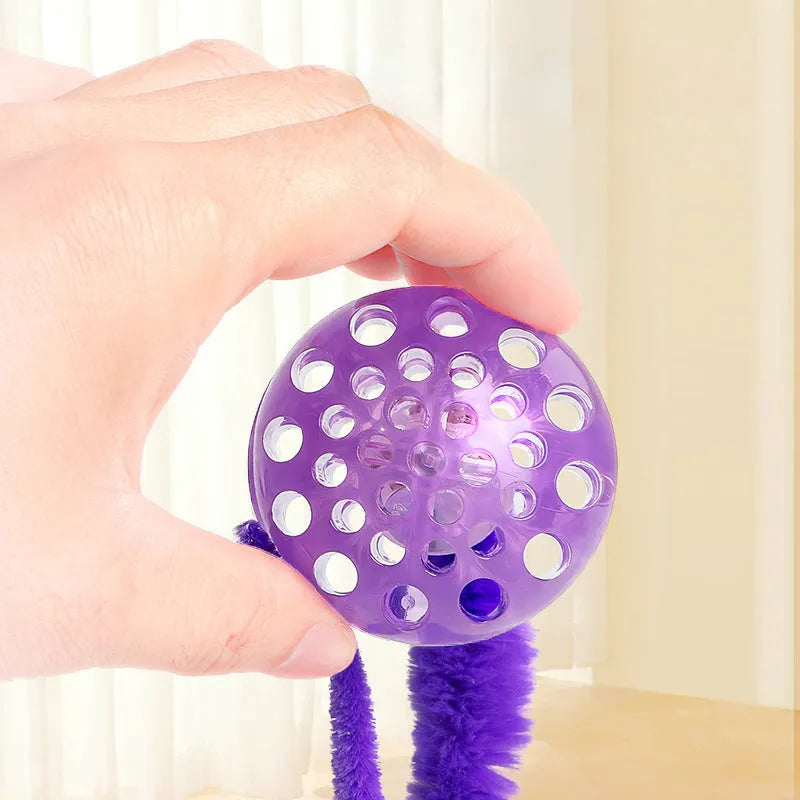 Interactive bouncy ball cat toy with plush tail in green, pink and purple colour options