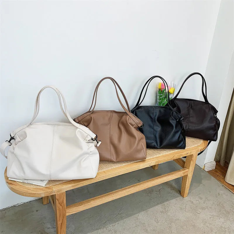 Large soft white PU messenger bag with a long cross-body shoulder strap and zip closure