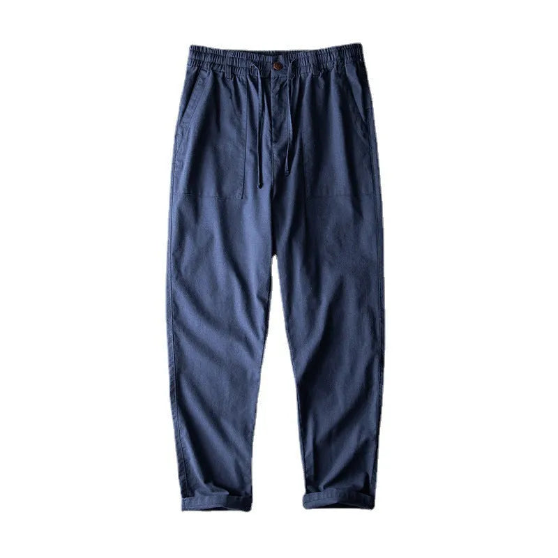 Men's solid colour linen casual trousers in mid-waist fit shown in grey, navy, or apricot.