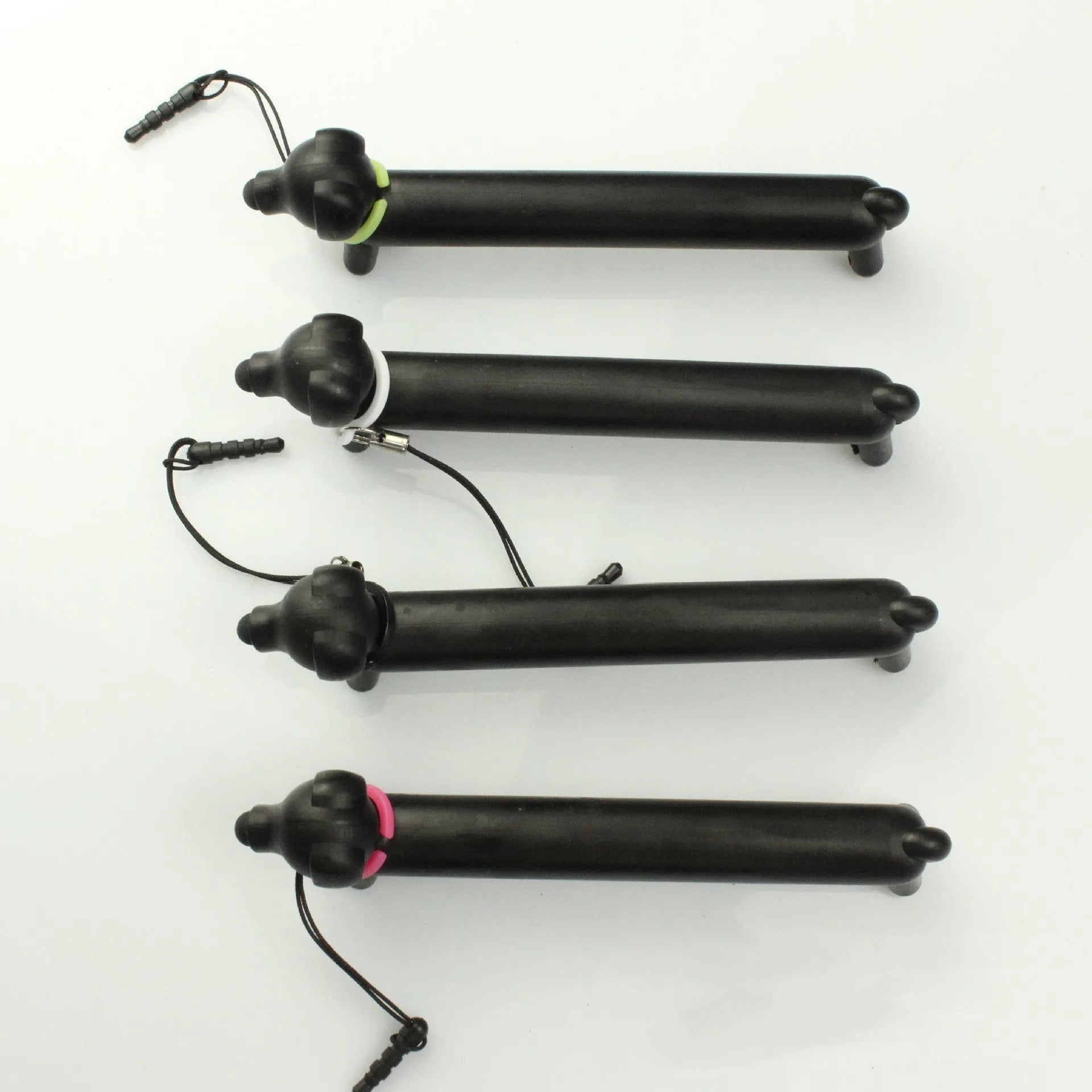 Black dog-shaped touch screen stylus with phone stand function on a white background