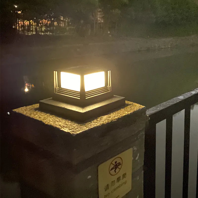 Outdoor solar pillar lamp, IP44, 160mm x 160mm x 110mm, abstract design, available in Black or White for courtyard and garden use.