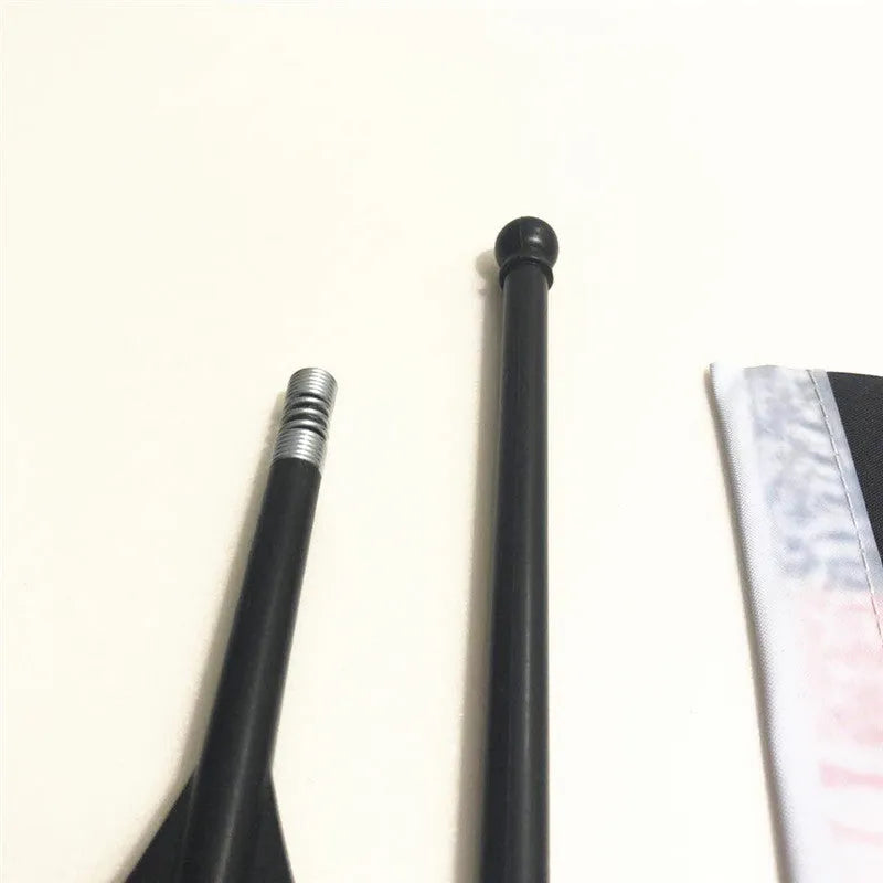 A plastic handlebar flagpole with a square polyester fabric flag attached, mounted on a bicycle.