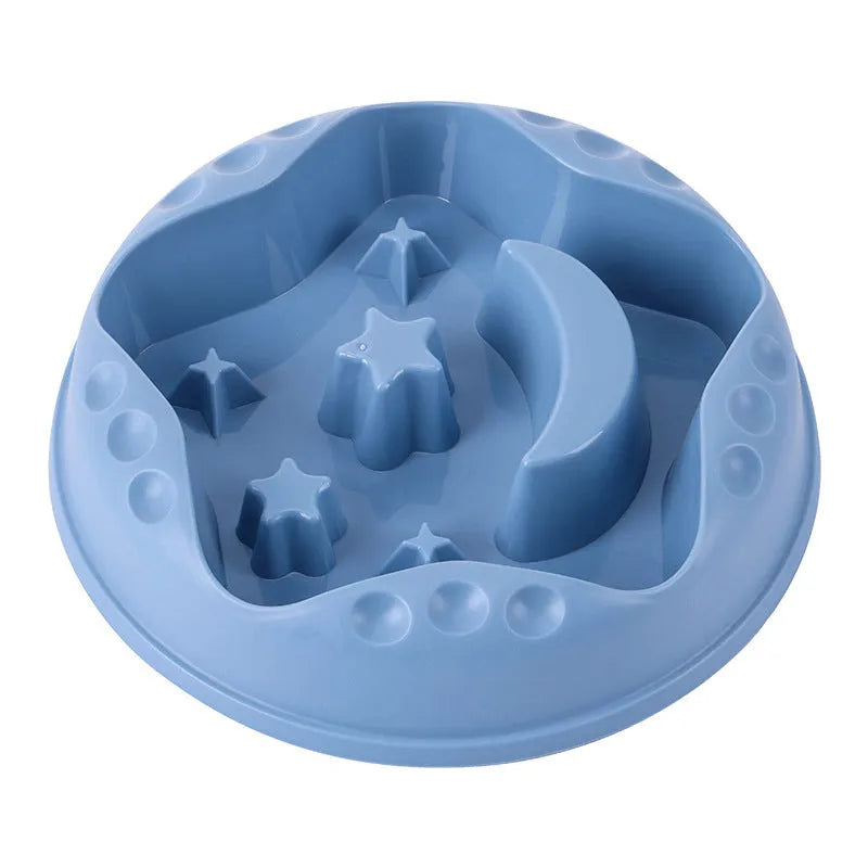 Large blue slow feed dog bowl with raised star and moon wing design on a wooden floor.