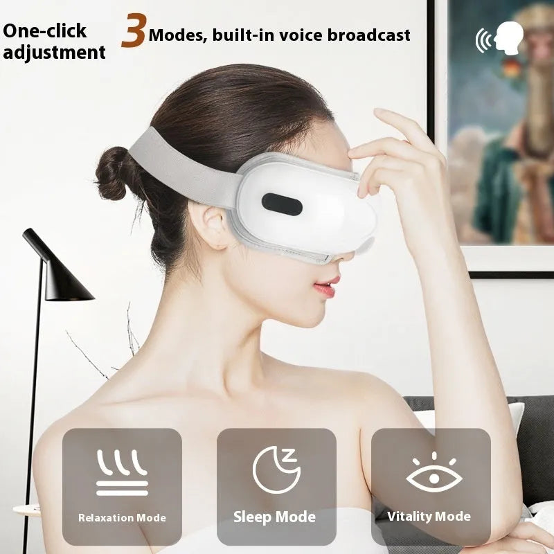 White rechargeable airbag eye massager with heat compress function on a grey background.