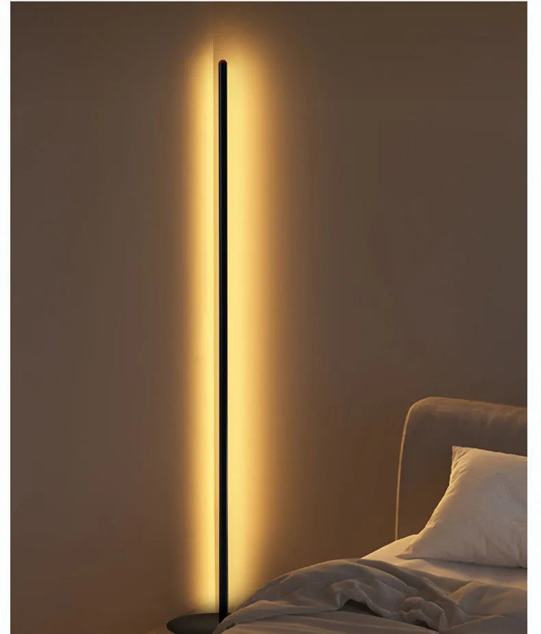 Vertical aluminium floor lamp in modern simple style shown at different heights on a table.