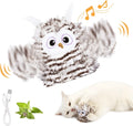 Grey automatic chirping owl cat toy with flapping wings on a floor.