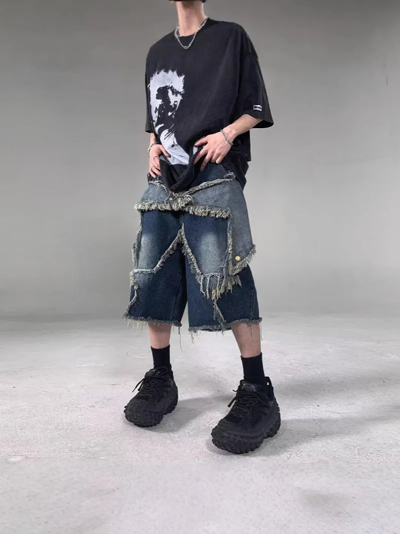 Blue denim shorts with distressed five-pointed star detailing and frayed hem, loose fit retro style
