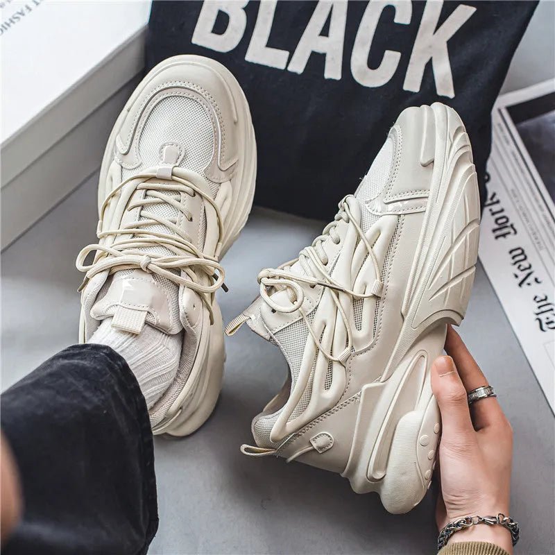 Men's beige and black sneakers with mesh upper, lace-up front, and rubber sole